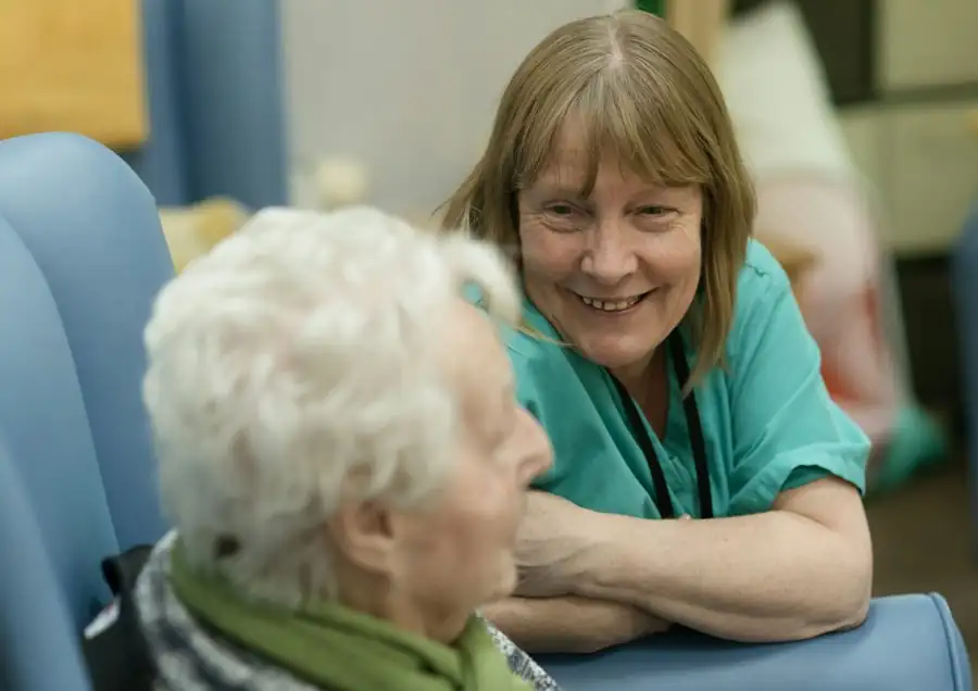 A nurse smiling with an elderly patient